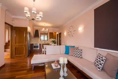 a living room with a couch and a table at Casa Leone Suites in Stalos