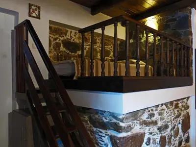 a staircase in a room with a stone wall at 