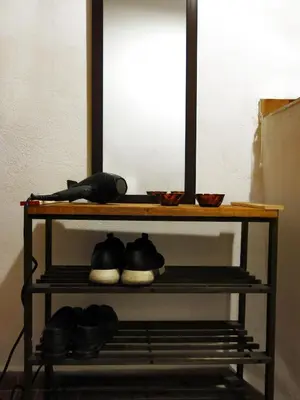a shelf with shoes on it with a mirror at 