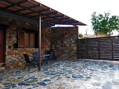 a patio with a table and chairs under a wooden pergola at 