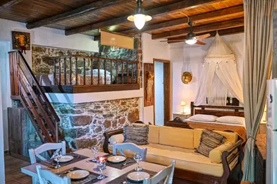 a living room with a couch and a bed and a table at 