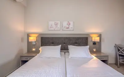 a bedroom with a bed with two white pillows at Christina Beach Hotel in Kissamos