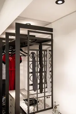 a closet with a black rack with ties at A-Loft Superior Experience in Chania Town