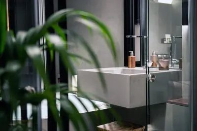 a bathroom with a white sink and a plant at A-Loft Superior Experience in Chania Town