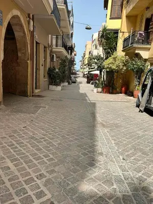 a cobblestone street in a city with buildings at Sofias Home in Chania Town