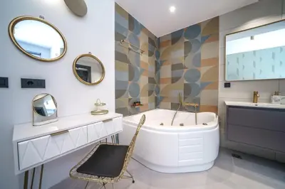 a bathroom with a tub and a sink and mirror at Naval villa-Panoramic villa with heated pool on the roof in Gerani Chanion