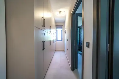 a hallway with white cabinets and a long corridor at Naval villa-Panoramic villa with heated pool on the roof in Gerani Chanion