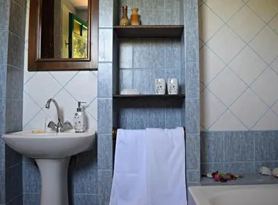 a bathroom with a sink and a toilet and a towel at Aspalathos Villas in Fílippos