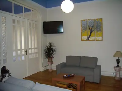 a living room with a couch and a tv at Neoclassical Glamour in Chania Town