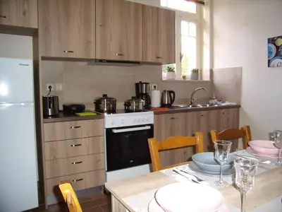 a kitchen with a stove and a table with chairs at Neoclassical Glamour in Chania Town