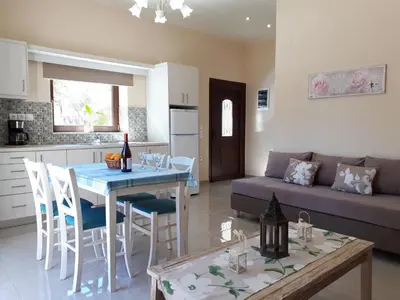 a kitchen and living room with a table and a couch at Iro City and Beach Boutique Homes in Chania Town