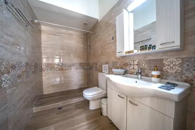 a bathroom with a toilet and a sink and a shower at Iro City and Beach Boutique Homes in Chania Town