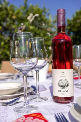 a bottle of wine sitting on a table with two wine glasses at Villa Anerocurù by Chania city in Chania Town