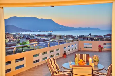 a balcony with a table and chairs and a view of the ocean at Kissamos View Apartment in Kissamos