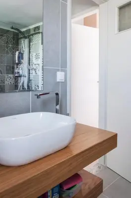 a bathroom with a white sink on a wooden counter at Veranda Apartment in Chania Town