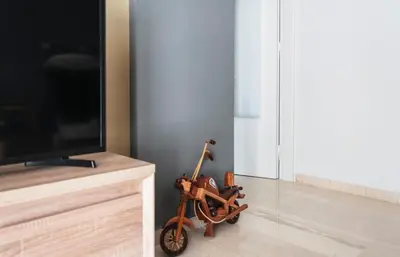 a scooter is sitting on the floor next to a tv at Veranda Apartment in Chania Town