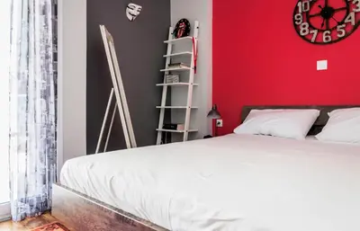 a bedroom with a white bed and a red wall at Veranda Apartment in Chania Town