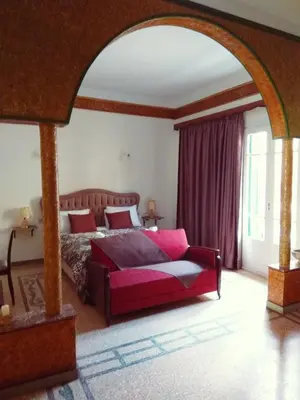 a bedroom with a bed and a couch in it at The Manor House in the Old Town in Chania Town