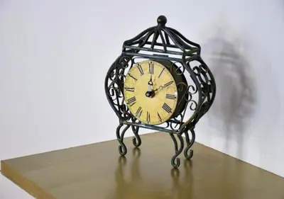 a small clock sitting on top of a table at The Manor House in the Old Town in Chania Town