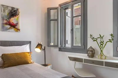 a bedroom with a bed and a window at Casa Minaretto in Chania Town