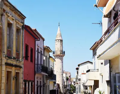 a city street with a clock tower in the background at Minaret's View ζήστε στην αύρα της παλιάς πόλης in Chania Town