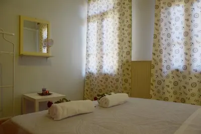 a bedroom with a bed with two towels on it at Minaret's View ζήστε στην αύρα της παλιάς πόλης in Chania Town