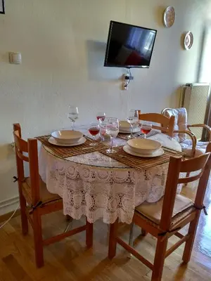 a dining room table with glasses of wine on it at Minaret's View ζήστε στην αύρα της παλιάς πόλης in Chania Town