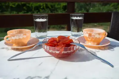 a table with two cups and a bowl of food at Nikis Apartments Kisamos in Drapaniás