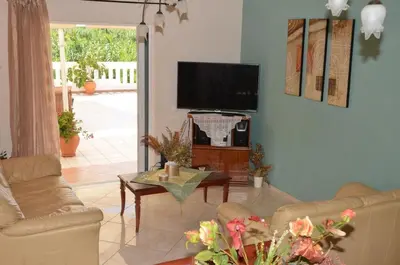 a living room with a couch and a tv at Kostaspant apartment in Gerani Chanion