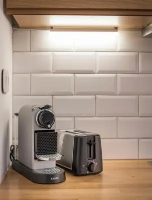 a kitchen with a toaster and a printer on a counter at Evlimeni Suites in Chania Town
