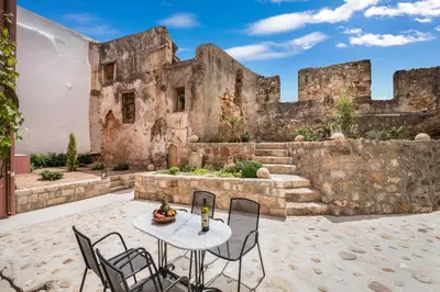 a table and chairs in front of a building at Evlimeni Suites in Chania Town