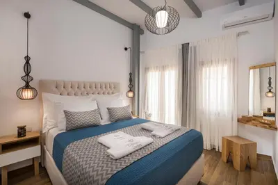 a bedroom with a bed with two towels on it at Evlimeni Suites in Chania Town