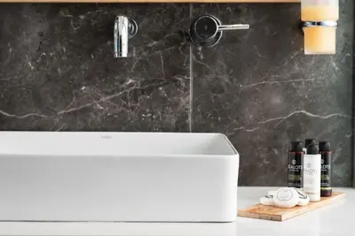 a bathroom with a white sink and a shower at Maleme Mare in Maleme