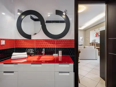 a bathroom with a red counter and a mirror at Villa Athinais in Gerani Chanion