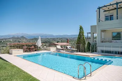 a swimming pool in front of a house at Villa Athinais in Gerani Chanion