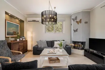 a living room with a couch and a table at Villa Athinais in Gerani Chanion