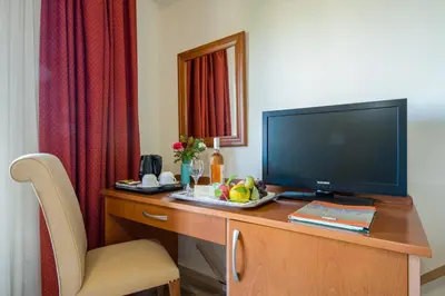 a hotel room with a desk with a television on it at ERIA RESORT for people with special abilities in Maleme