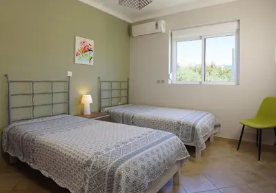 a room with two beds and a window at Elea in Kato Daratso