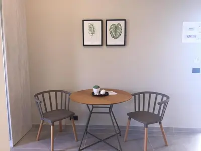 a small table and two chairs in a room at Sonio Beach - Que Bella Collection in Plataniás