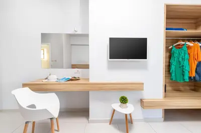 a room with a desk and a tv and a chair at Notus Chania Crete in Chania Town