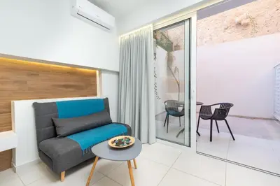 a living room with a couch and a table at Notus Chania Crete in Chania Town
