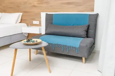a living room with a couch and a table at Notus Chania Crete in Chania Town