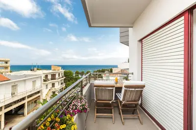 a balcony with chairs and a view of the ocean at La Vita Moderna in Chania Town