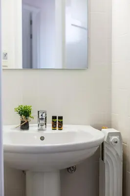 a white sink in a bathroom with a mirror at La Vita Moderna in Chania Town