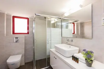 a bathroom with a sink and a toilet and a mirror at La Vita Moderna in Chania Town