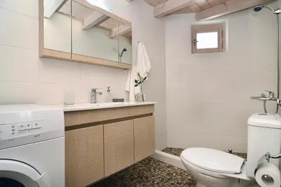 a bathroom with a washing machine and a sink at Mousa Thalia in Kissamos