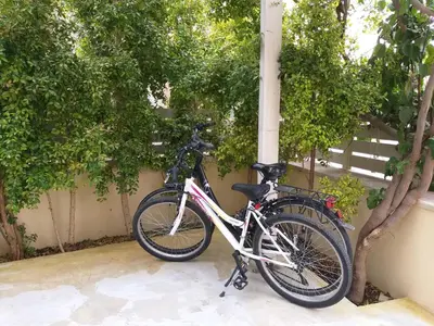 two bikes are parked next to a wall at Mousa Thalia in Kissamos