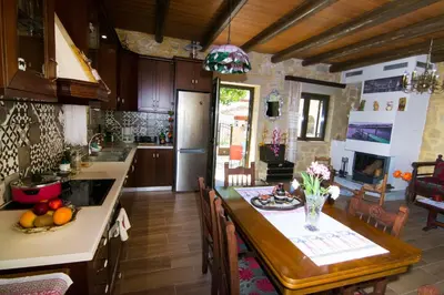 a kitchen with a table and a dining room at Mansion Rokka in Kissamos