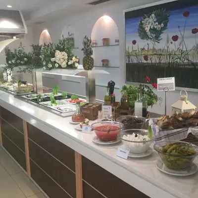 a counter with a bunch of food on it at Castro Beach Hotel in Maleme