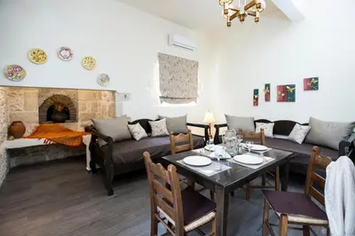 a living room with a table and a couch at Margarita's Stone House in Plátanos